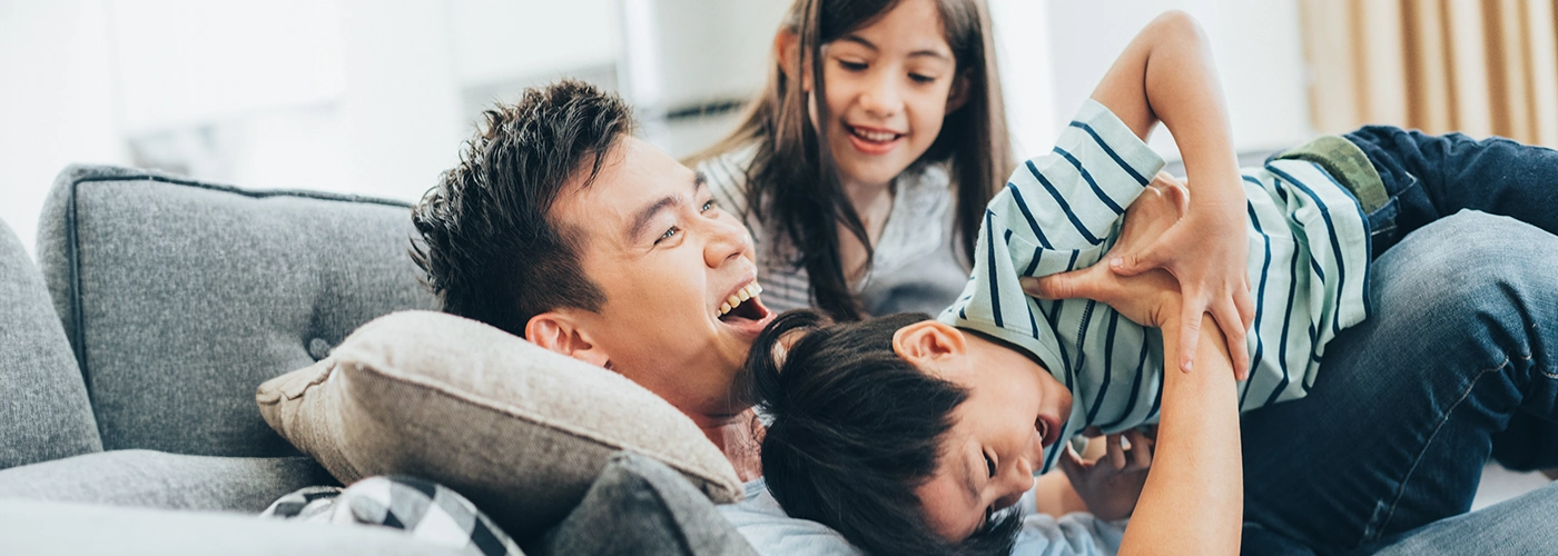 father is having fun with his hyperactive children